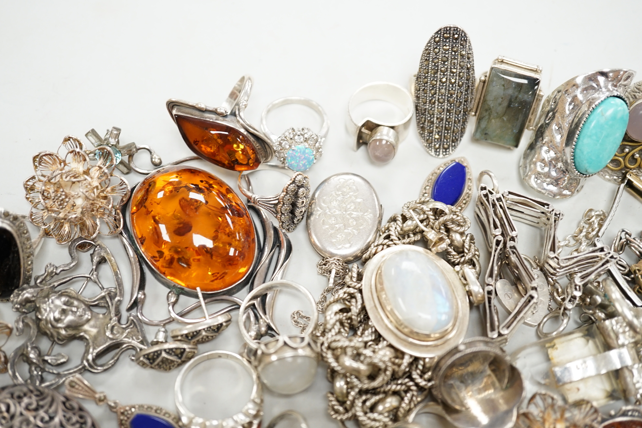 A quantity of 925 and white metal jewellery including amber set brooch, Art Nouveau style brooch and assorted dress rings.